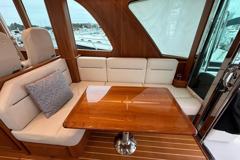Kay Lee Jean Yacht Photos Pics Interior of 2023 Sabre 43 Salon Express yacht with elegant seating and wooden table.