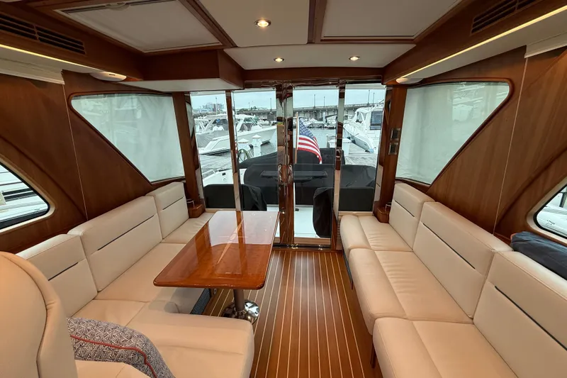 Kay Lee Jean Yacht Photos Pics Luxurious interior of 2023 Sabre 43 Salon Express yacht with elegant seating and wooden accents.