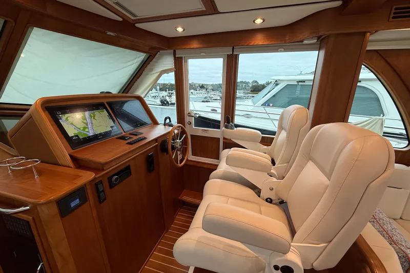 Kay Lee Jean Yacht Photos Pics Luxurious interior of 2023 Sabre 43 Salon Express yacht with plush seating and navigation screens.