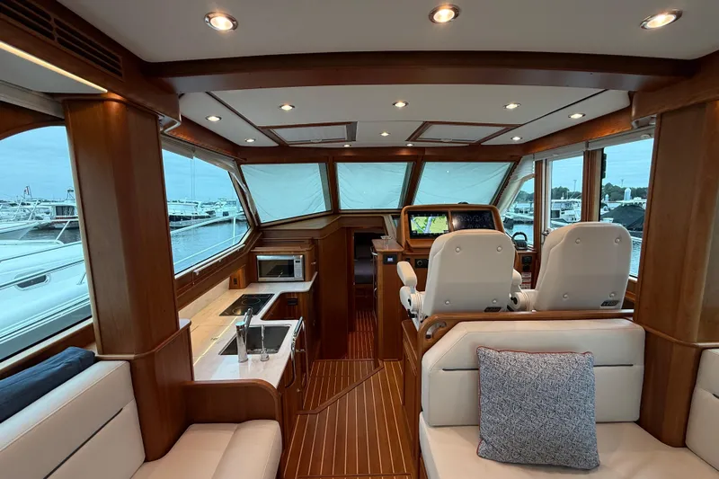 Kay Lee Jean Yacht Photos Pics Interior of 2023 Sabre 43 Salon Express yacht with luxurious seating and navigation area.