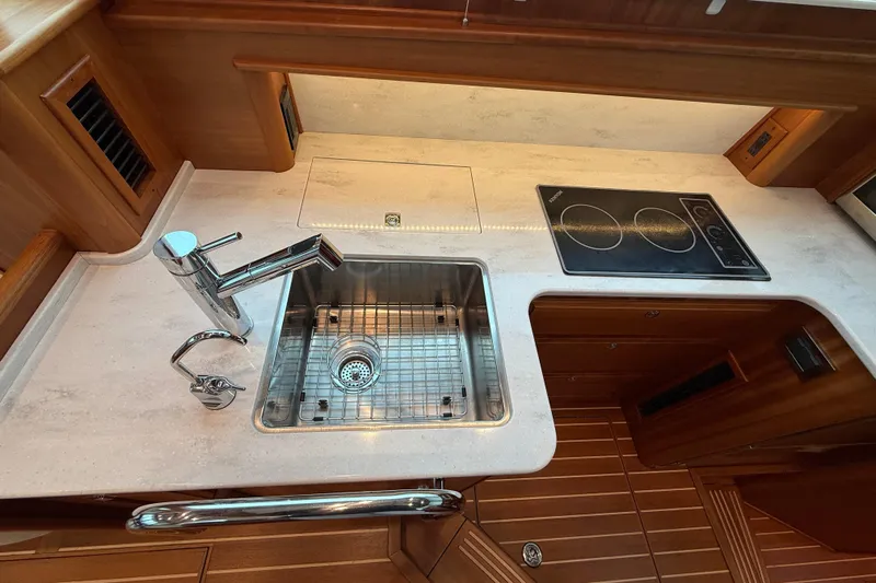 Kay Lee Jean Yacht Photos Pics 2023 Sabre 43 Salon Express yacht kitchen with sink and stovetop.