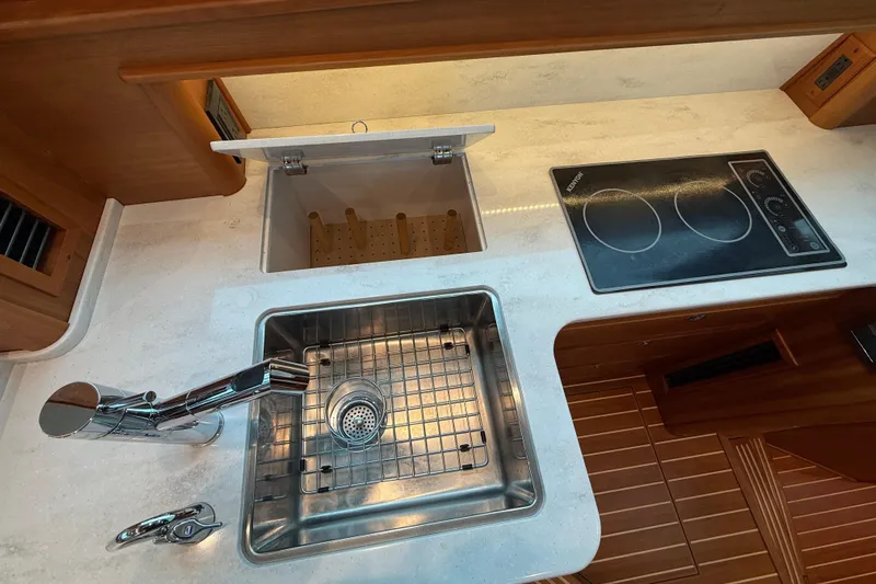 Kay Lee Jean Yacht Photos Pics Modern kitchen area in 2023 Sabre 43 Salon Express yacht with sink and cooktop.