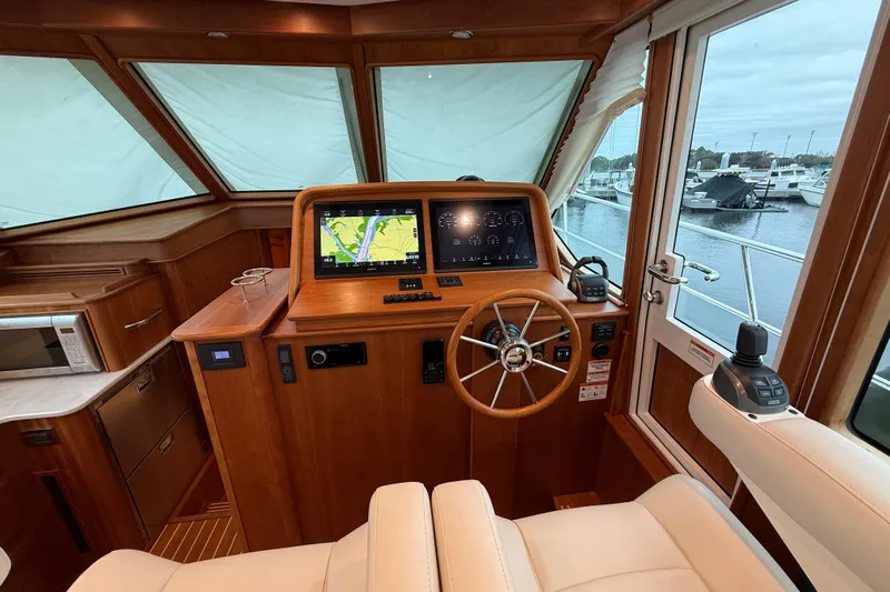 Kay Lee Jean Yacht Photos Pics 2023 Sabre 43 Salon Express helm with navigation screens and wooden steering wheel.
