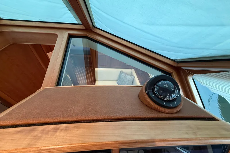 Kay Lee Jean Yacht Photos Pics 2023 Sabre 43 Salon Express interior with compass and wooden accents.
