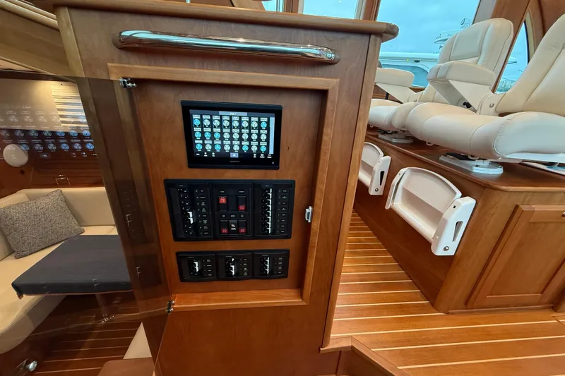 Kay Lee Jean Yacht Photos Pics 2023 Sabre 43 Salon Express interior with control panel and luxurious seating.