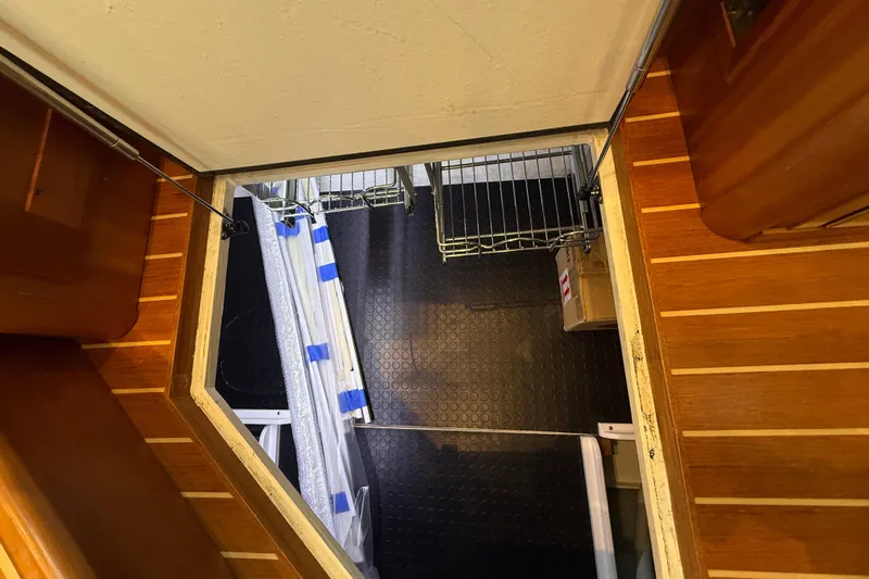 Kay Lee Jean Yacht Photos Pics 2023 Sabre 43 Salon Express interior with wooden flooring and storage access.