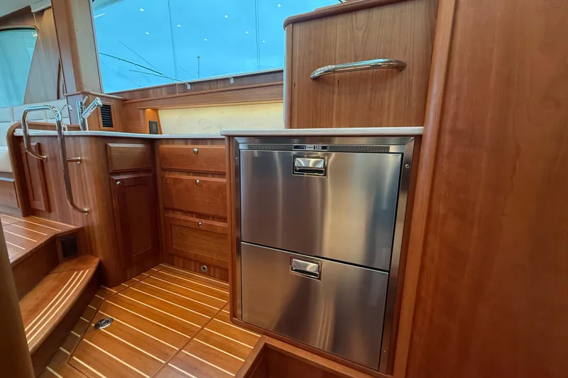 Kay Lee Jean Yacht Photos Pics Luxurious interior of 2023 Sabre 43 Salon Express yacht with wood cabinetry and stainless appliances.