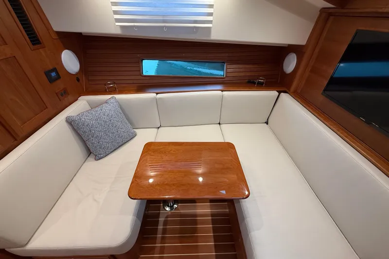 Kay Lee Jean Yacht Photos Pics Luxurious interior of 2023 Sabre 43 Salon Express with elegant seating and wooden table.
