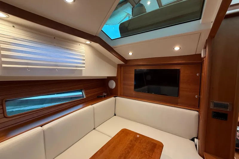 Kay Lee Jean Yacht Photos Pics Luxurious interior of 2023 Sabre 43 Salon Express yacht with wood paneling and skylight.