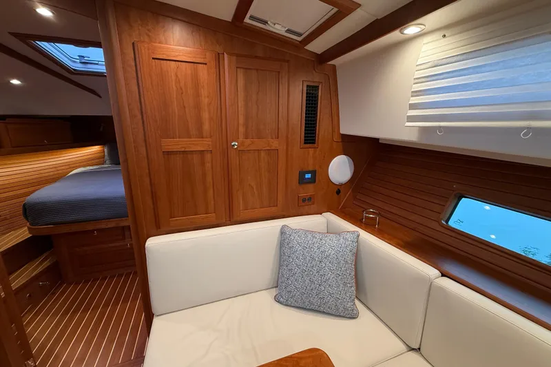 Kay Lee Jean Yacht Photos Pics Luxurious interior of 2023 Sabre 43 Salon Express yacht with wood finish and cozy seating.