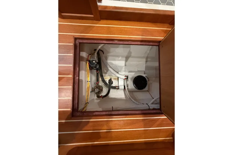 Kay Lee Jean Yacht Photos Pics 2023 Sabre 43 Salon Express interior compartment with visible wiring and plumbing.