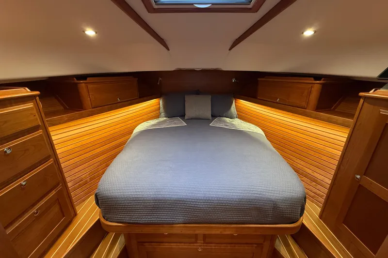 Kay Lee Jean Yacht Photos Pics Luxurious cabin interior of 2023 Sabre 43 Salon Express yacht with cozy bed and wooden finish.
