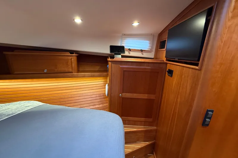 Kay Lee Jean Yacht Photos Pics 2023 Sabre 43 Salon Express cabin interior with wood paneling and TV.