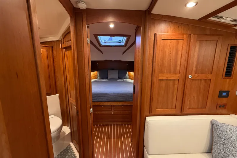 Kay Lee Jean Yacht Photos Pics 2023 Sabre 43 Salon Express interior with wood finish, cozy bedroom, and modern bathroom.
