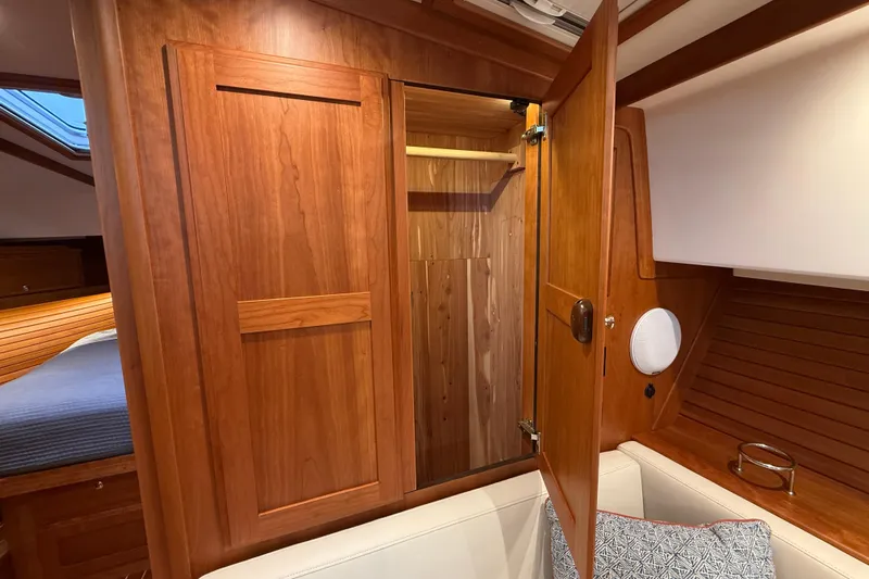 Kay Lee Jean Yacht Photos Pics 2023 Sabre 43 Salon Express interior with wooden closet and seating area.