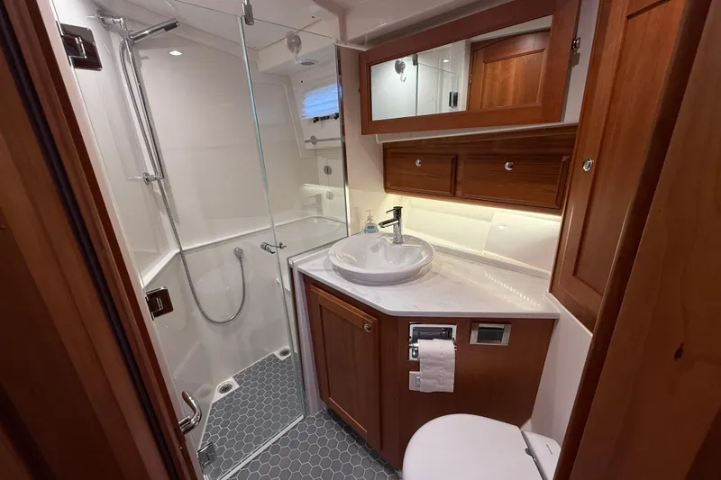 Kay Lee Jean Yacht Photos Pics Luxurious bathroom in 2023 Sabre 43 Salon Express yacht with modern fixtures and wood accents.