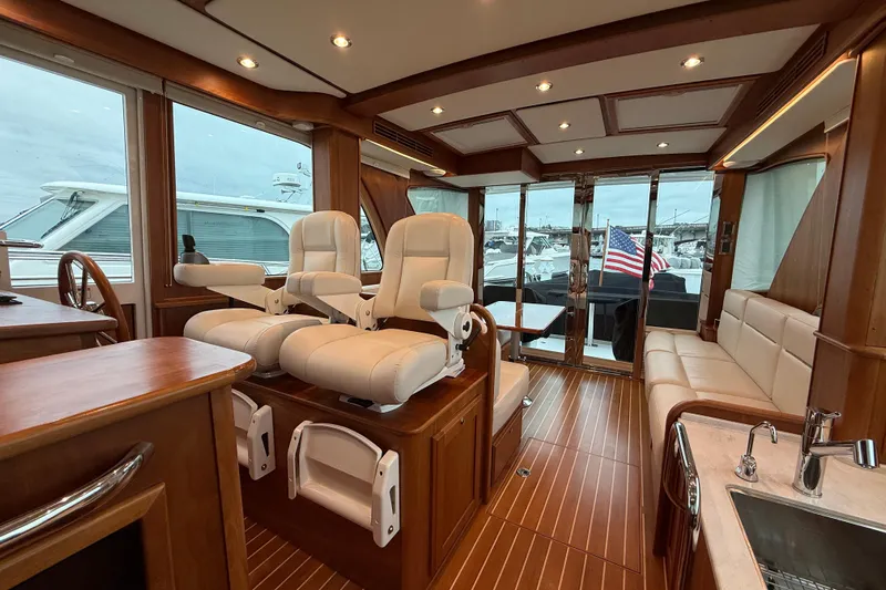 Kay Lee Jean Yacht Photos Pics Luxurious interior of 2023 Sabre 43 Salon Express yacht with plush seating and elegant wood finishes.