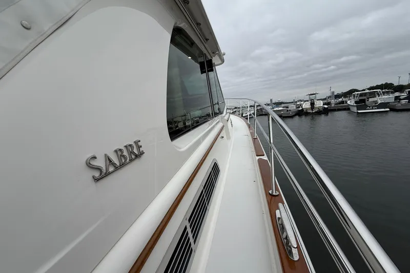 Kay Lee Jean Yacht Photos Pics 2023 Sabre 43 Salon Express yacht docked at marina, showcasing sleek design and craftsmanship.