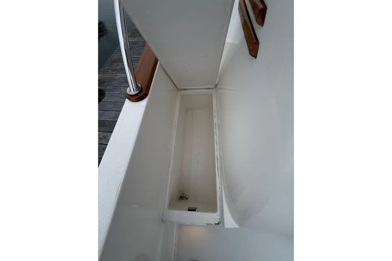 Kay Lee Jean Yacht Photos Pics 2023 Sabre 43 Salon Express deck detail with railing and storage compartment.