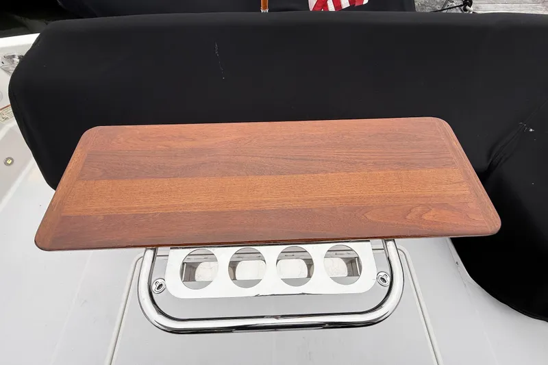 Kay Lee Jean Yacht Photos Pics Wooden table on 2023 Sabre 43 Salon Express yacht, featuring stainless steel cup holders.