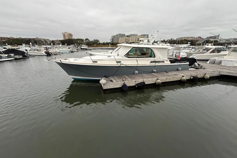 Kay Lee Jean Yacht Photos Pics 2023 Sabre 43 Salon Express yacht docked in a marina, surrounded by other boats.