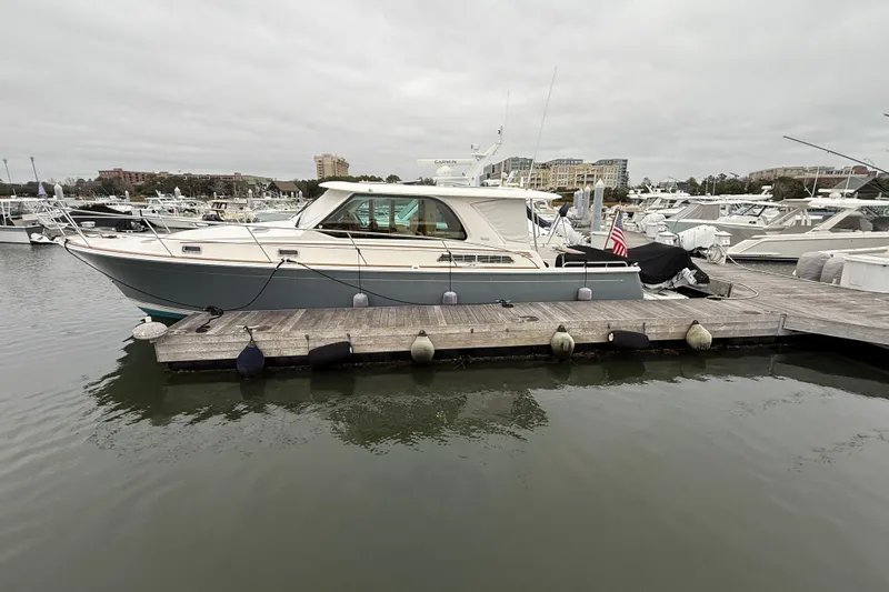 Kay Lee Jean Yacht Photos Pics 2023 Sabre 43 Salon Express yacht docked at marina, overcast sky.