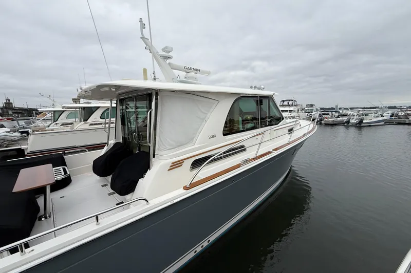 Kay Lee Jean Yacht Photos Pics 2023 Sabre 43 Salon Express yacht docked at marina under cloudy sky.