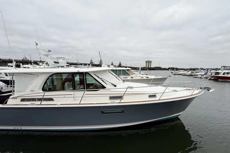 Kay Lee Jean Yacht Photos Pics 2023 Sabre 43 Salon Express yacht docked in a marina under cloudy skies.