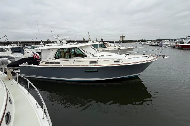 Kay Lee Jean Yacht Photos Pics 2023 Sabre 43 Salon Express yacht docked in a marina, overcast sky.