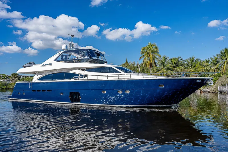La Bella Vita Yacht Photos Pics Luxurious 2006 Ferretti Yachts 830 cruising on a sunny day, surrounded by palm trees.