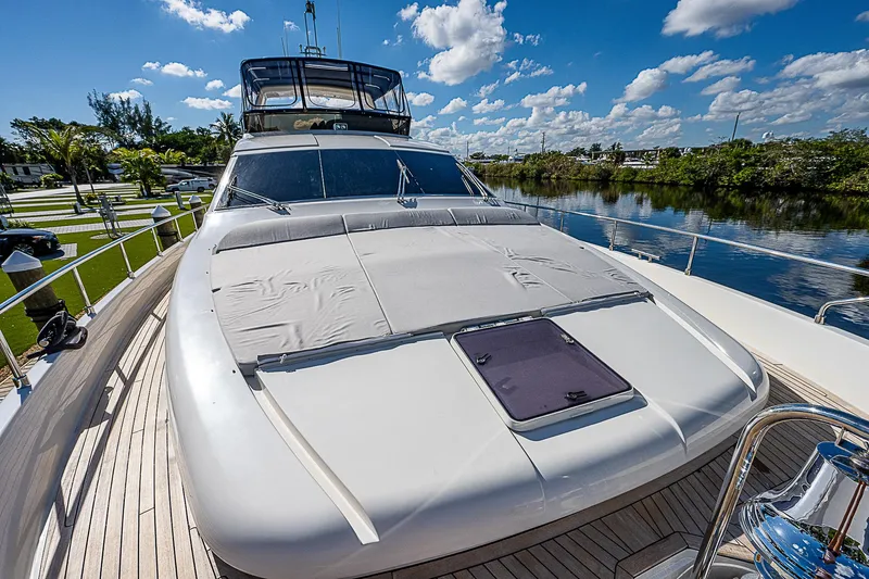 La Bella Vita Yacht Photos Pics Luxury 2006 Ferretti Yachts 830 on a sunny day, docked by a serene river.