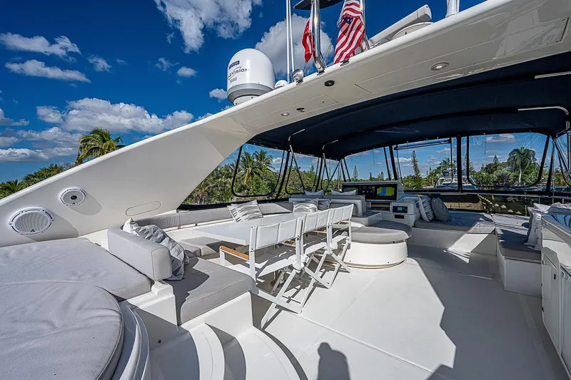 La Bella Vita Yacht Photos Pics Luxurious 2006 Ferretti Yachts 830 flybridge with seating, under a clear blue sky.