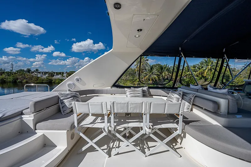 La Bella Vita Yacht Photos Pics Luxurious 2006 Ferretti Yachts 830 with spacious outdoor seating under a clear blue sky.