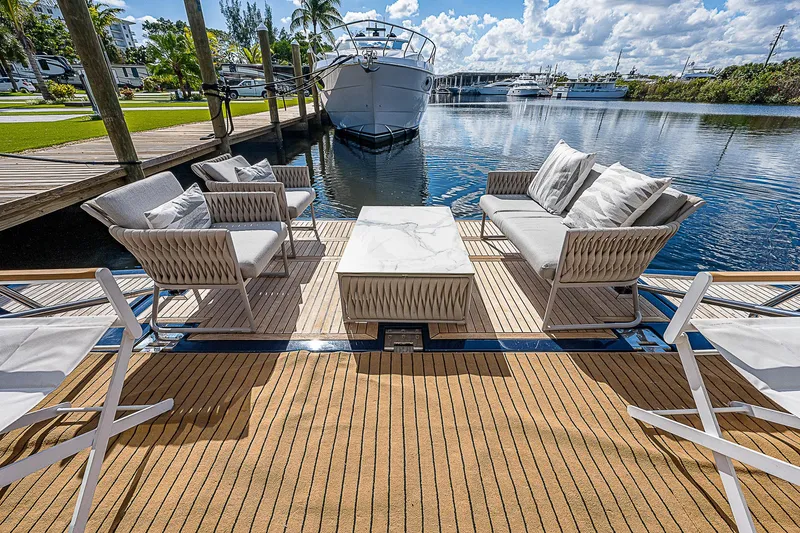 La Bella Vita Yacht Photos Pics Luxury outdoor seating on 2006 Ferretti Yachts 830, docked by serene waterfront.