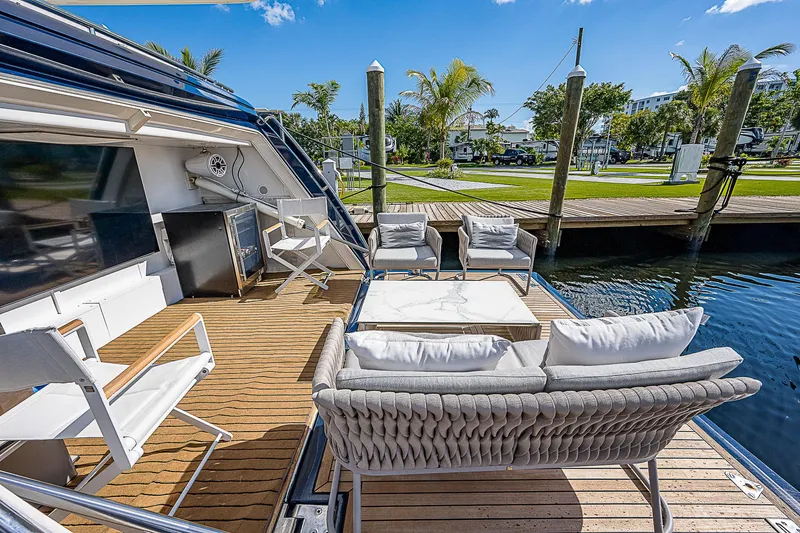 La Bella Vita Yacht Photos Pics Luxurious 2006 Ferretti Yachts 830 with elegant outdoor seating on a sunny dock.
