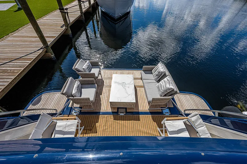 La Bella Vita Yacht Photos Pics Luxurious 2006 Ferretti Yachts 830 with elegant outdoor seating on a serene waterfront.