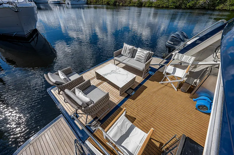 La Bella Vita Yacht Photos Pics Luxury outdoor seating on 2006 Ferretti Yachts 830 deck, overlooking serene water.