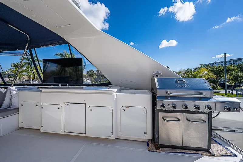 La Bella Vita Yacht Photos Pics Outdoor kitchen on 2006 Ferretti Yachts 830 with grill and TV under blue sky.