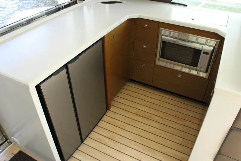 To The Moon And Back Yacht Photos Pics 2014 Cruisers Yachts 45 Cantius kitchen area with microwave and refrigerator.