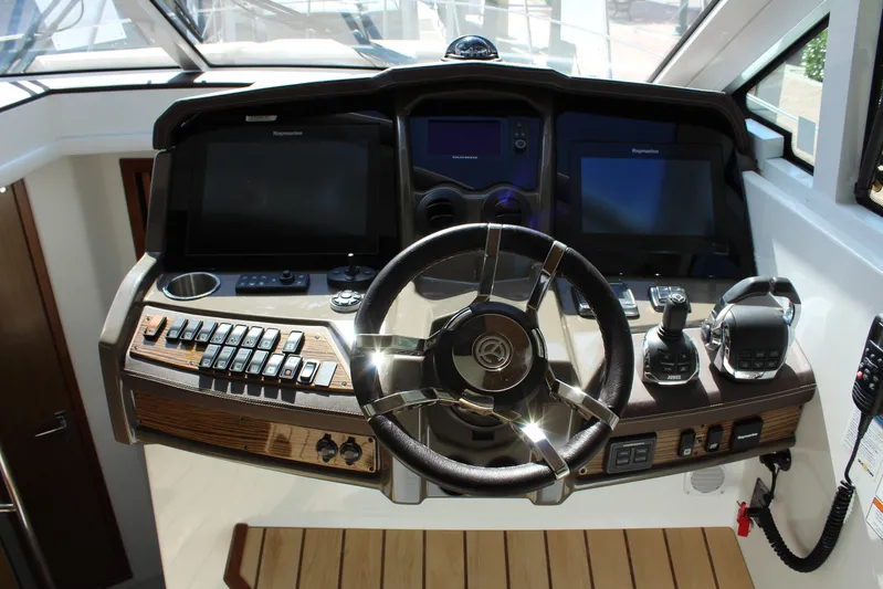 To The Moon And Back Yacht Photos Pics 2014 Cruisers Yachts 45 Cantius helm with modern controls.
