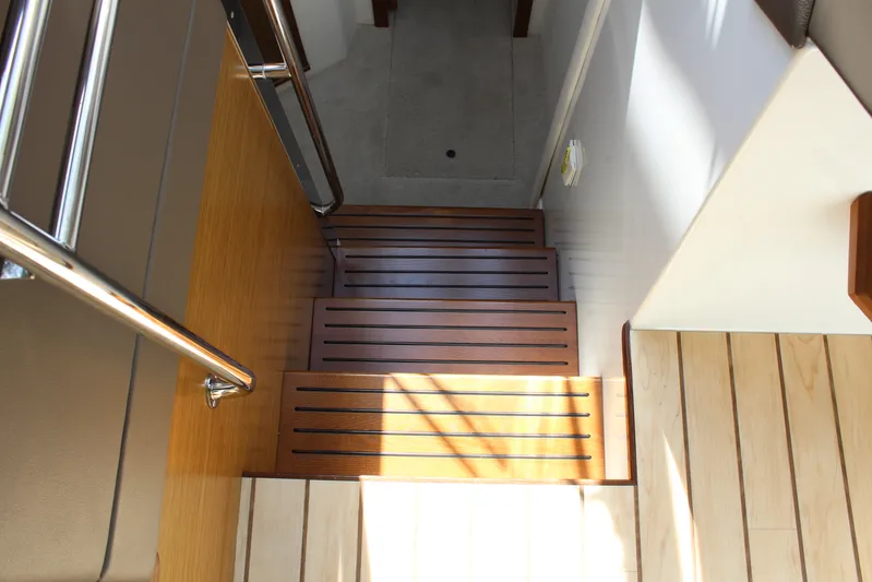 To The Moon And Back Yacht Photos Pics Wooden stairs inside the 2014 Cruisers Yachts 45 Cantius.