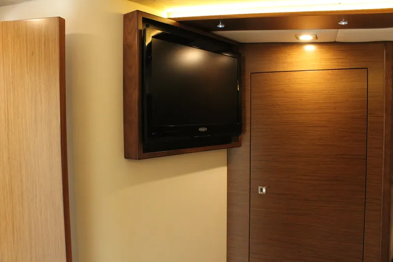To The Moon And Back Yacht Photos Pics Interior of 2014 Cruisers Yachts 45 Cantius with TV and wooden doors.