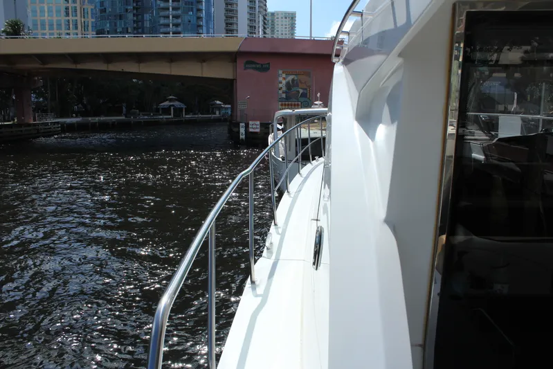 To The Moon And Back Yacht Photos Pics Cruisers Yachts 45 Cantius 2014 on a river under a bridge.