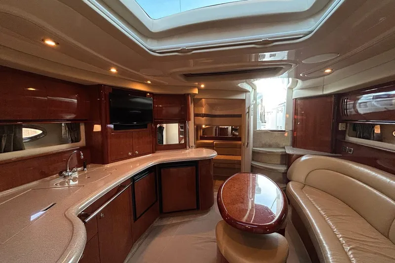  Yacht Photos Pics Luxurious interior of a 2003 Sea Ray 420 Sundancer yacht with elegant wood finishes.
