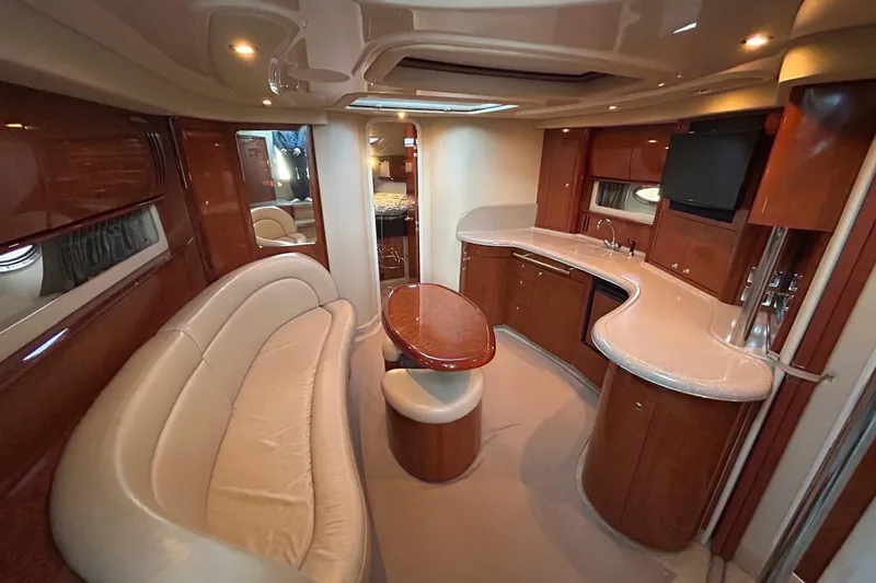  Yacht Photos Pics Luxurious interior of a 2003 Sea Ray 420 Sundancer yacht with elegant seating and kitchenette.