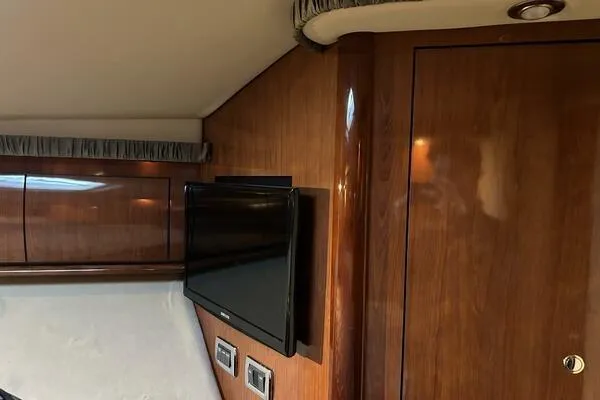  Yacht Photos Pics 2003 Sea Ray 420 Sundancer interior with wood paneling and mounted TV.