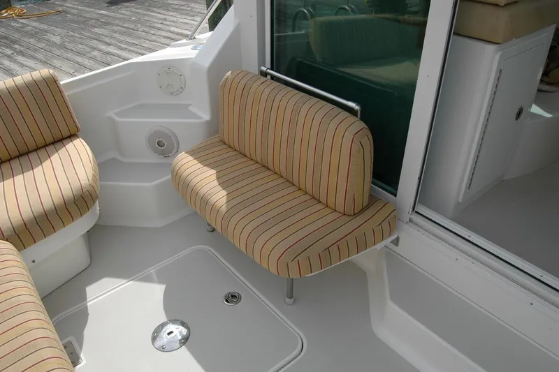 Au Lapin Agile Yacht Photos Pics 2014 Back Cove 34 boat interior with striped seating and white deck.