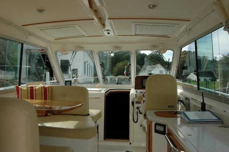 Au Lapin Agile Yacht Photos Pics Interior of a 2014 Back Cove 34 boat, featuring seating and navigation area.