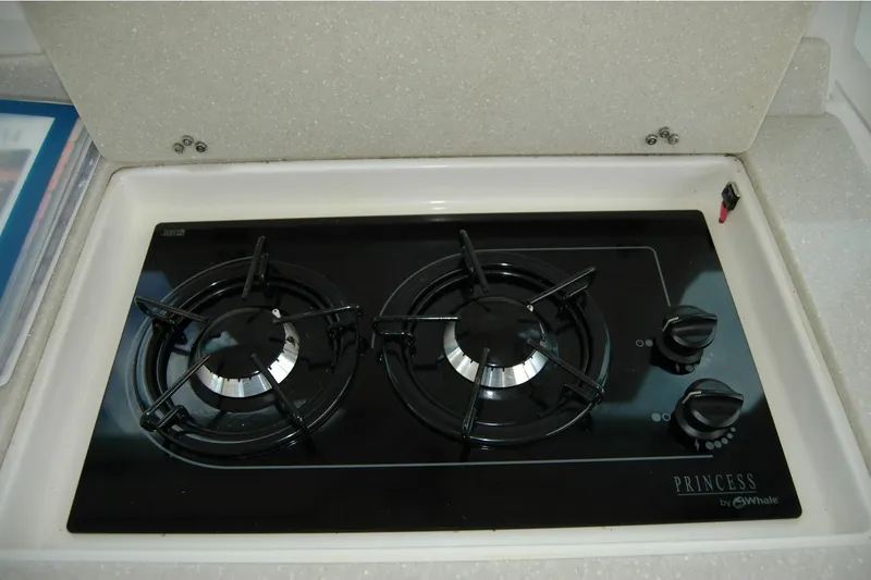Au Lapin Agile Yacht Photos Pics Gas stove in 2014 Back Cove 34 yacht kitchen, featuring two burners and sleek design.