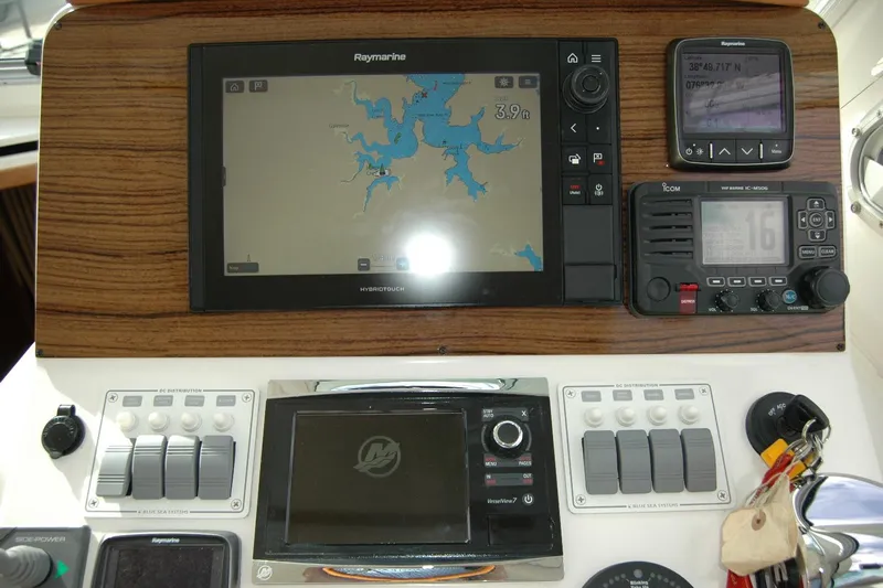 Au Lapin Agile Yacht Photos Pics 2014 Back Cove 34 helm with navigation and communication equipment, featuring Raymarine and Icom systems.